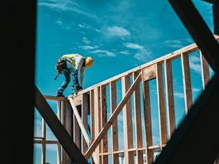 Bauarbeiter beim Aufbau eines Hauses in Bauweise mit Holz