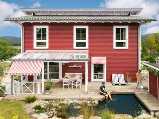 Fertighaus E 20-168.1 - Fertighaus im skandinavischen Landhausstil & Hampton-Flair von SchwörerHaus - Österreich, Außenansicht 3